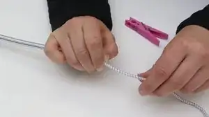Attach the shock cord to a clothes pin or similar item.