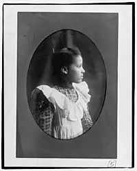 A young woman facing right