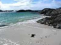Beach at Port nam Murrach. This small beach is found at the end of a rough walk from the Arisaig road past Rhue House. This view is looking north.