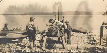 Boys building kayaks at Adventure Island Camp. Adventure Island is also known as Big Strawberry Island.