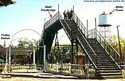 The footbridge allowed trolley passengers to safely cross the train tracks into the park; it was a major attraction for youngsters who ascended to view the approaching smoke-billowing trains (1952).