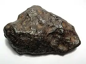 A 700-gram (25 oz) individual Chinga iron meteorite (Ataxite, class IVB). This specimen is about 9 centimeters wide.