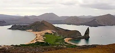Image 16Pinnacle Rock on Bartolomé Island, with Santiago in the background and a ferry on the right for scale (from Galápagos Islands)