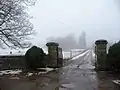 The estate's gated entrance and driveway