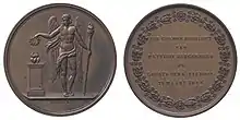 Both sides of a medal. The front depicts Eros or another classical love deity. The reverse has the message in Dutch.