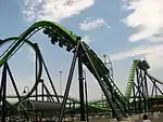 Green roller coaster preparing to go upside-down