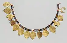 Headdress; 2600–2500 BC; gold (the leaves), lapis lazuli (the blue beads) and carnelian (the orange beads); length: 38.5&nbsp;cm; Metropolitan Museum of Art