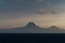 Isanotski (8,104&nbsp;ft; 2,470&nbsp;m) and Roundtop (6,128&nbsp;ft; 1,868&nbsp;m) volcanoes as seen from the Unimak Pass in the morning light.