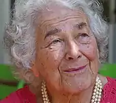 A photograph of a woman looking up and to the right