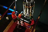 Researchers deploy a CTD-rosette at night.