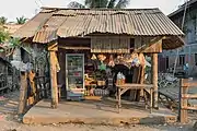Old little shop with corrugated iron roof, selling drinks in a refrigerator and petrol in plastic bottles, on the island of Don Khon.