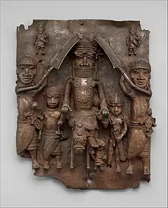 Plaque equestrian an Oba on horseback with attendants; between 1550 and 1680; brass; height: 49.5&nbsp;cm (197⁄16 in.), width: 41.9 (161⁄2 in.), diameter: 11.4&nbsp;cm (41⁄2 in.); Metropolitan Museum of Art