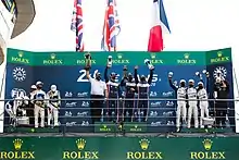 A podium ceremony with drivers and delegates