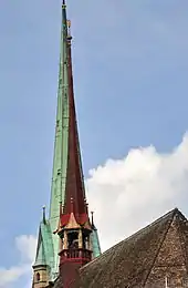 The 27.1 metres (88.9&nbsp;ft) high ridge turret of Predigerkirche Zürich, its 96 metres (315&nbsp;ft) clock tower in the background.