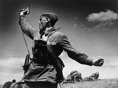 Image 9KombatPhotograph credit: Max AlpertKombat (Russian for 'battalion commander') is a black-and-white photograph by Soviet photographer Max Alpert. It depicts a Soviet military officer, armed with a TT pistol, raising his unit for an attack during World War II. This work is regarded as one of the most iconic Soviet World War II photographs, yet neither the date nor the subject is known with certainty. According to the most widely accepted version, it depicts junior politruk Aleksei Gordeyevich Yeryomenko, minutes before his death on 12 July 1942, in Voroshilovgrad Oblast, now part of Ukraine. The photograph is in the archives of RIA Novosti, a Russian state-owned news agency.More selected pictures