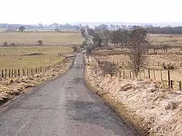 Country lane disappearing over the horizon