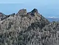 Unicorn Peak (left) and Unicorn Horn (right) seen from Hurricane Hill,with Port Angeles and Strait of Juan de Fuca in the distance.