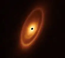 Image 29Astronomers used the James Webb Space Telescope to image the warm dust around a nearby young star, Fomalhaut, in order to study the first asteroid belt ever seen outside of the Solar System in infrared light. (from Cosmic dust)