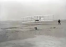 An airplane flying on a beach (from Human history)