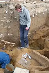 Extraction of a figurine by archaeologists